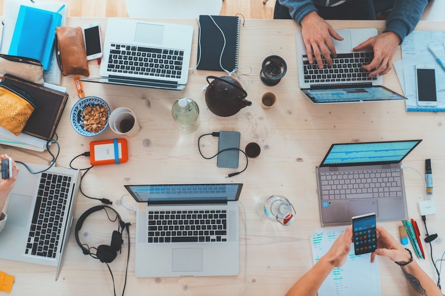 IT support team collaborating around a laptop