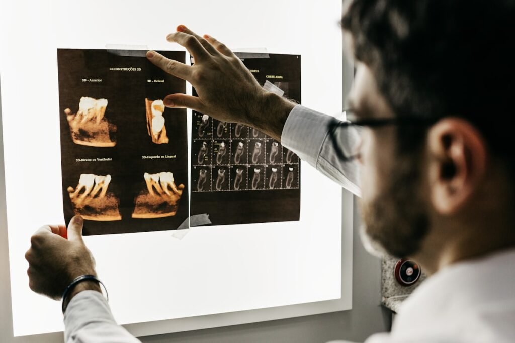Dentist and hygienist reviewing patient imaging in a modern dental operatory